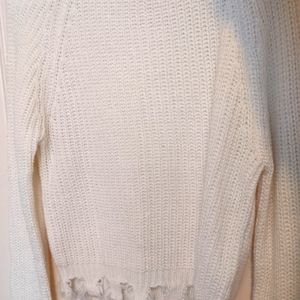 Frayed white knitted sweater